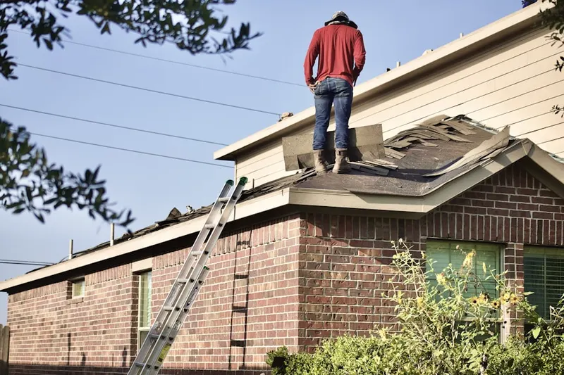 Professional roofer working on a residential roof in Cheval